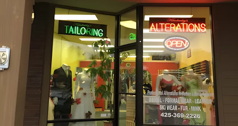 Kimberley’s storefront windows displaying garments and tailoring and alterations signs